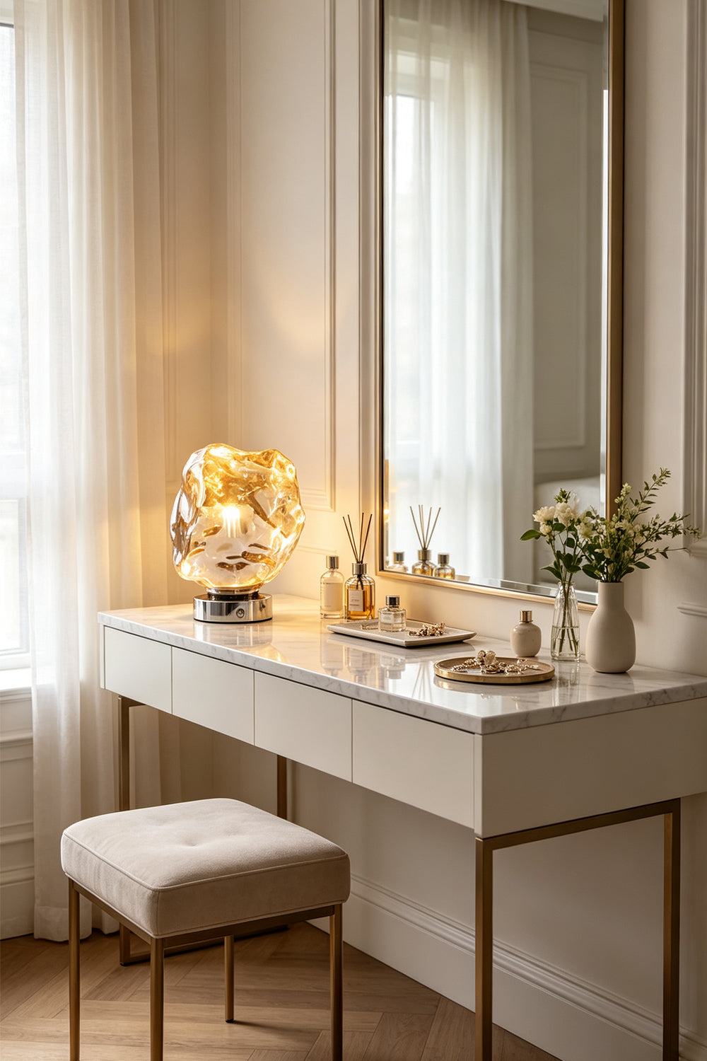 Vega Molten Metal Table Lamp on a stylish vanity with a mirror and decorative items.