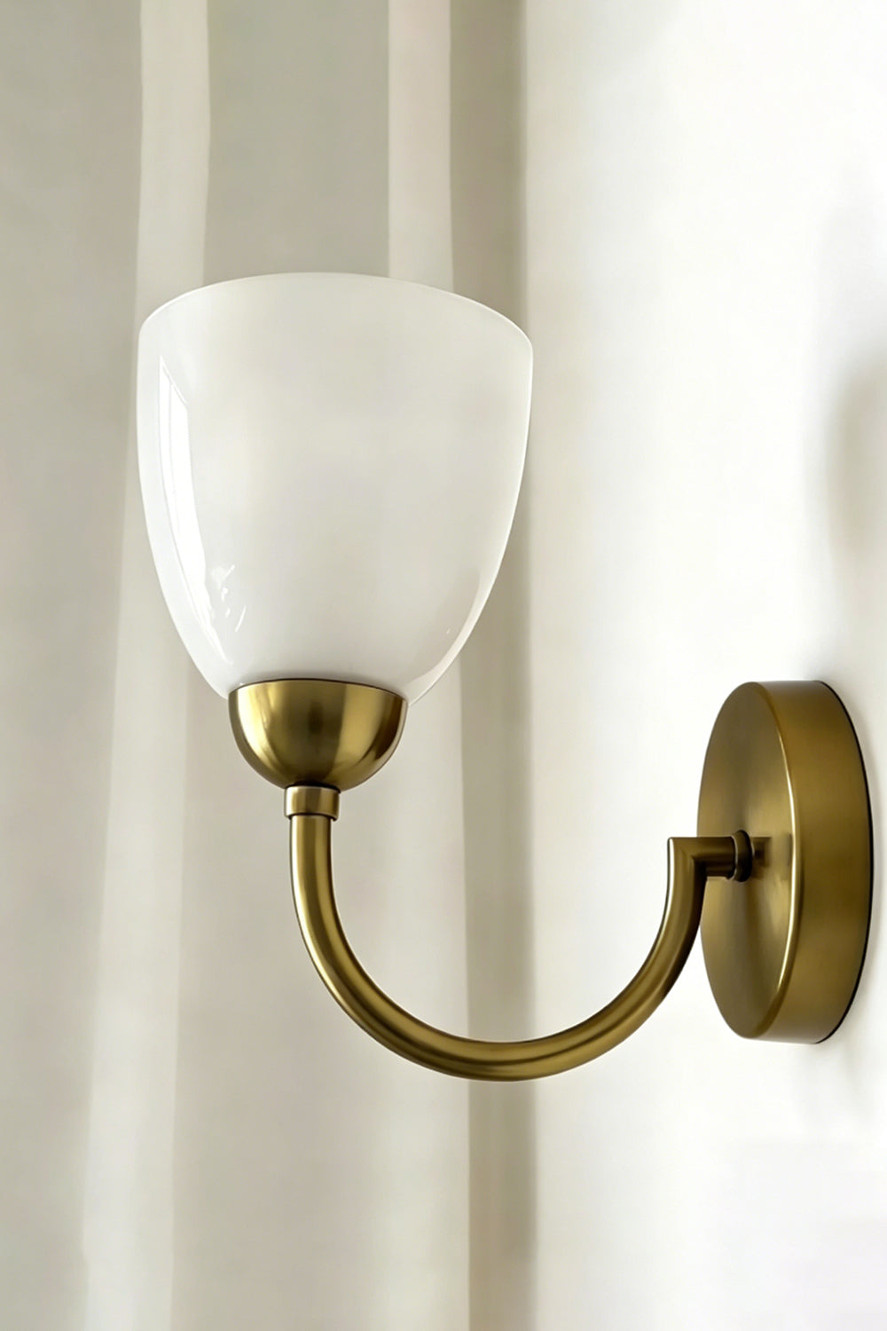 Veil Curve Glass Wall Lamp with white shade | Metal, Glass | Detail shot of white shade profile against light wall | vexa lamps