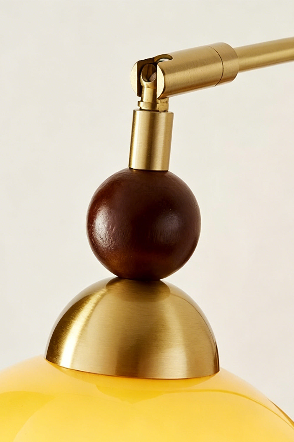 Vesper Caramel Gradient Wall Lamp | Glass, Metal, Wood | Detailed close-up showing the spherical dark wood bead accent and polished gold brass socket cap assembly | Detail shot | vexa lamps