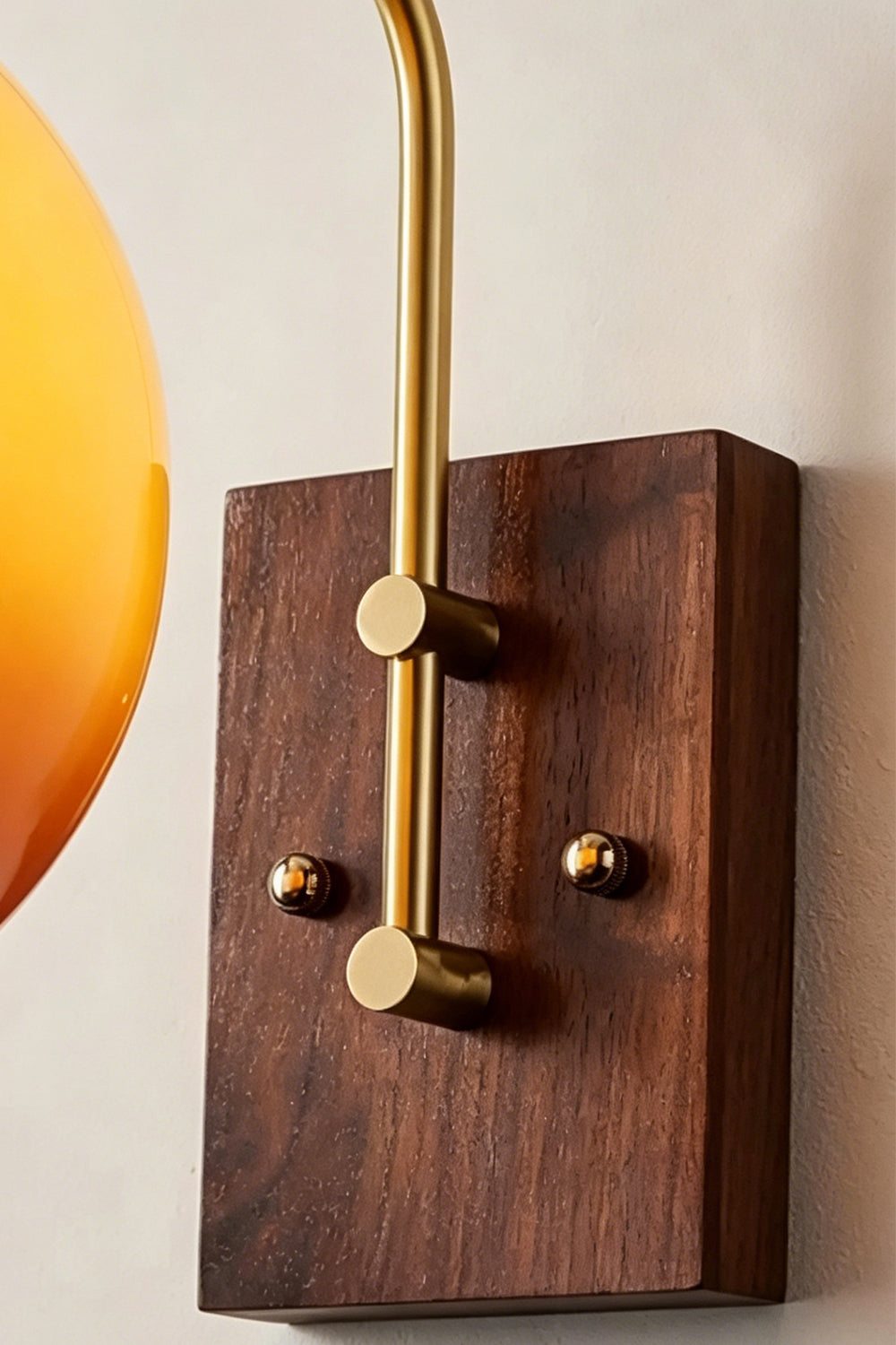 Vesper Caramel Gradient Wall Lamp | Glass, Metal, Wood | Close-up focus on the rich grain of the rectangular dark wood wall canopy and the brass mounting screws | Detail shot | vexa lamps