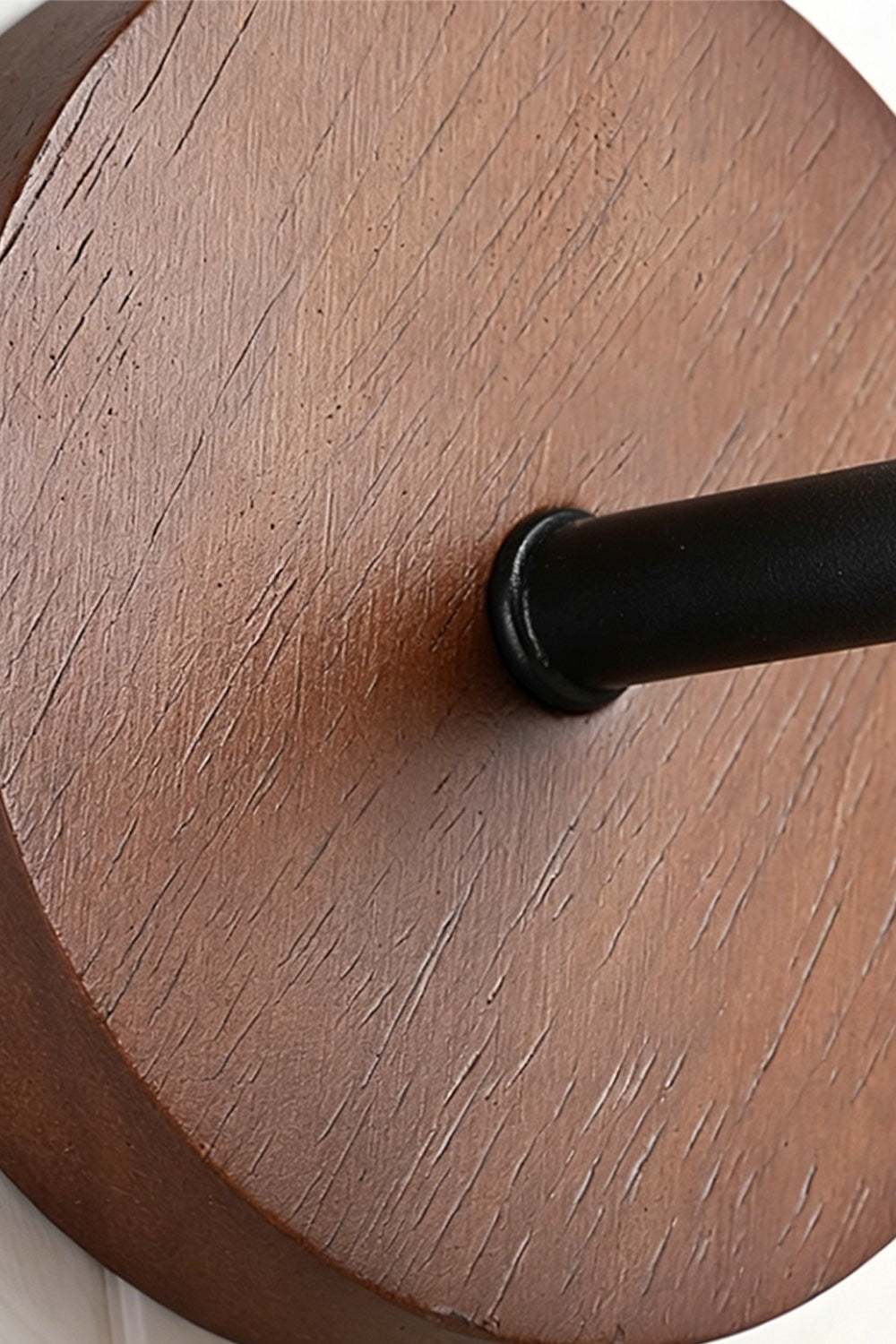 Vesper Cone Travertine Wall Light | Wood | Close-up of circular wood mounting plate and arm | vexa lamps
