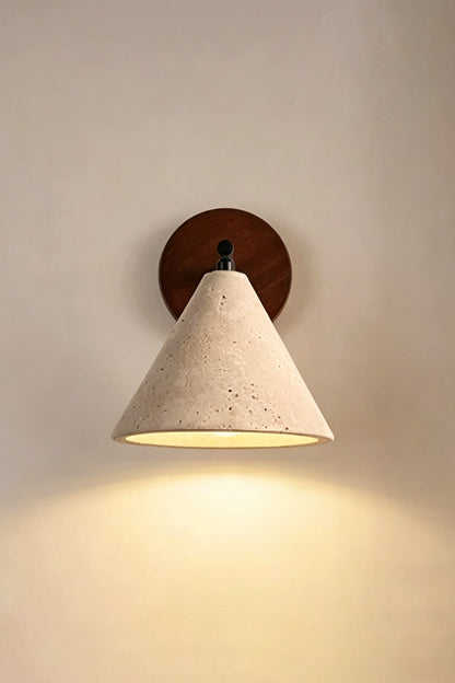 Vesper Cone Travertine Wall Light | Travertine, Wood | Lit sconce on neutral wall providing warm downlight | vexa lamps