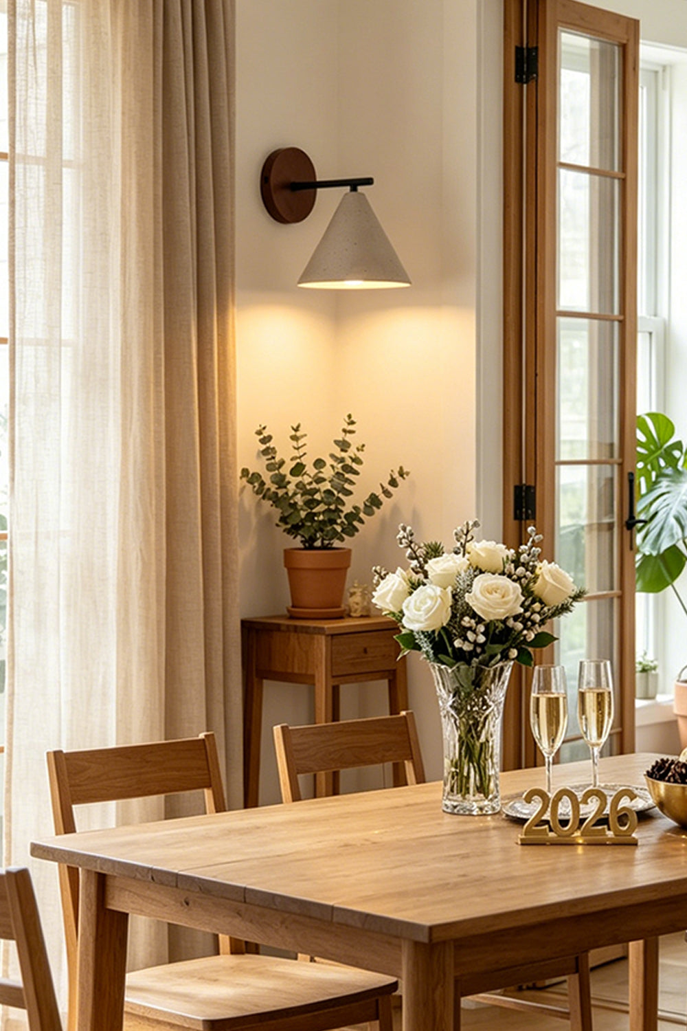 Vesper Cone Travertine Wall Light | Travertine, Wood | Dining area with wooden table and plants | vexa lamps