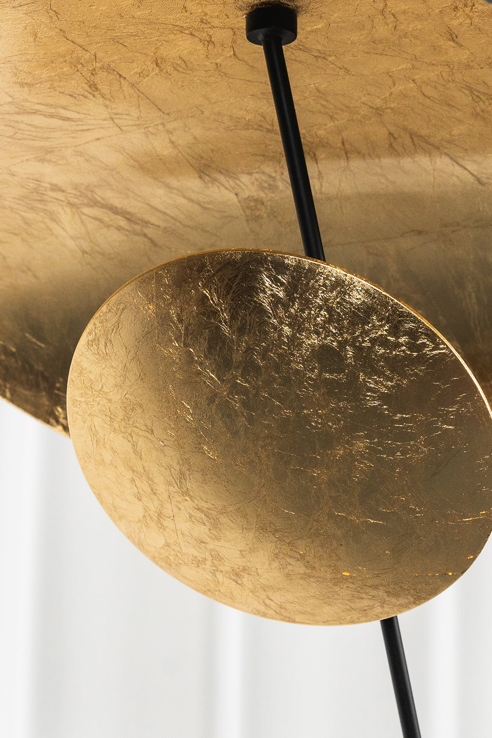 Voluta Horizon Metal Pendant Light | Metal | Macro focus on the textured gold foil surface of the lower decorative disc | Detail shot | vexa lamps
