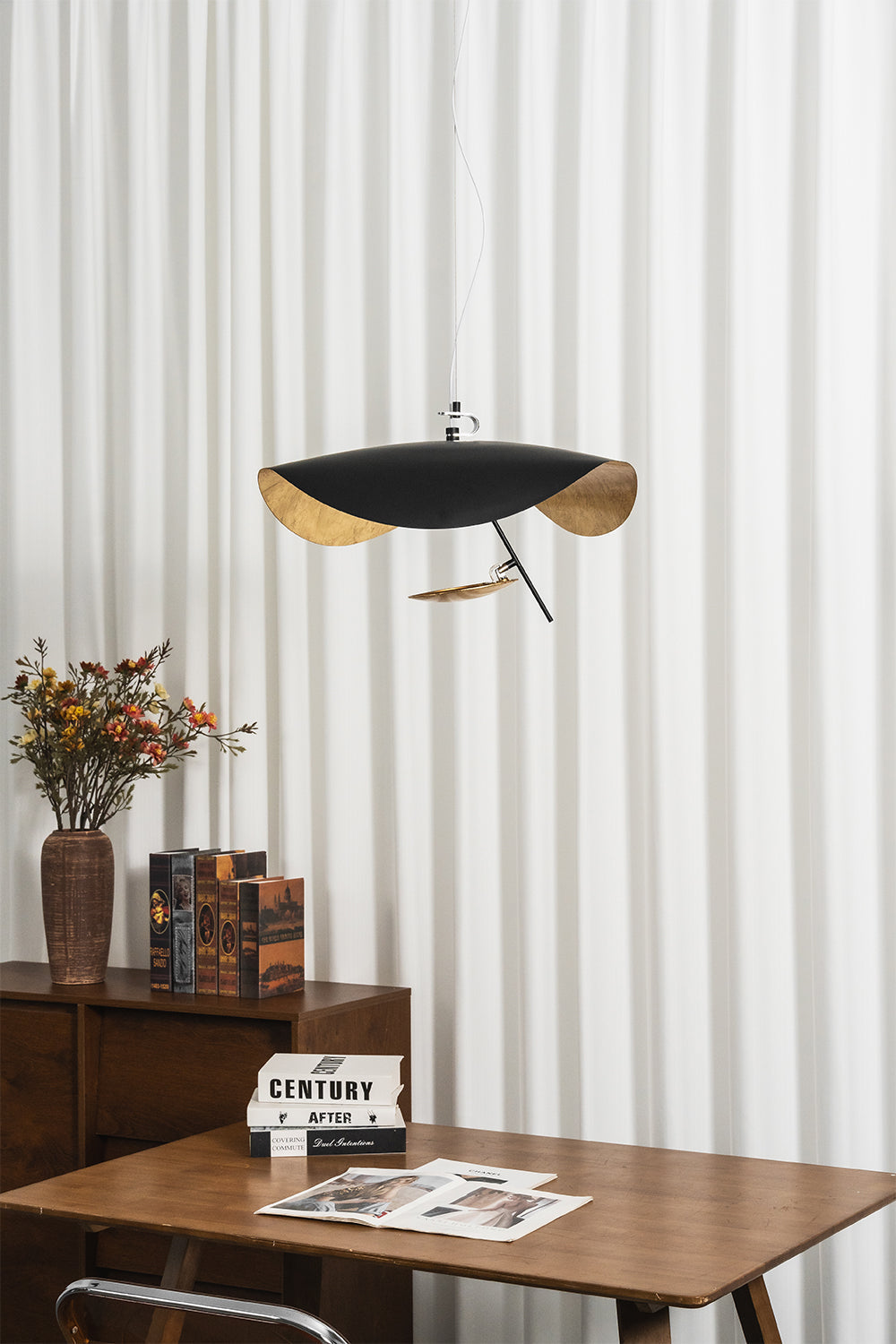Voluta Horizon Metal Pendant Light | Metal | Frontal view of the unlit black pendant hanging in front of striped vertical blinds | vexa lamps