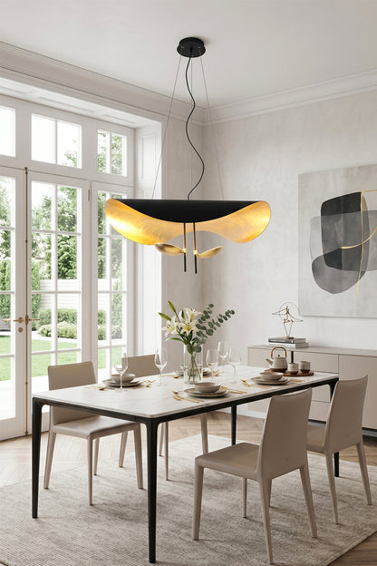 Voluta Horizon Metal Pendant Light | Metal | Black and gold variant providing warm light over a minimalist dining table and upholstered chairs | vexa lamps