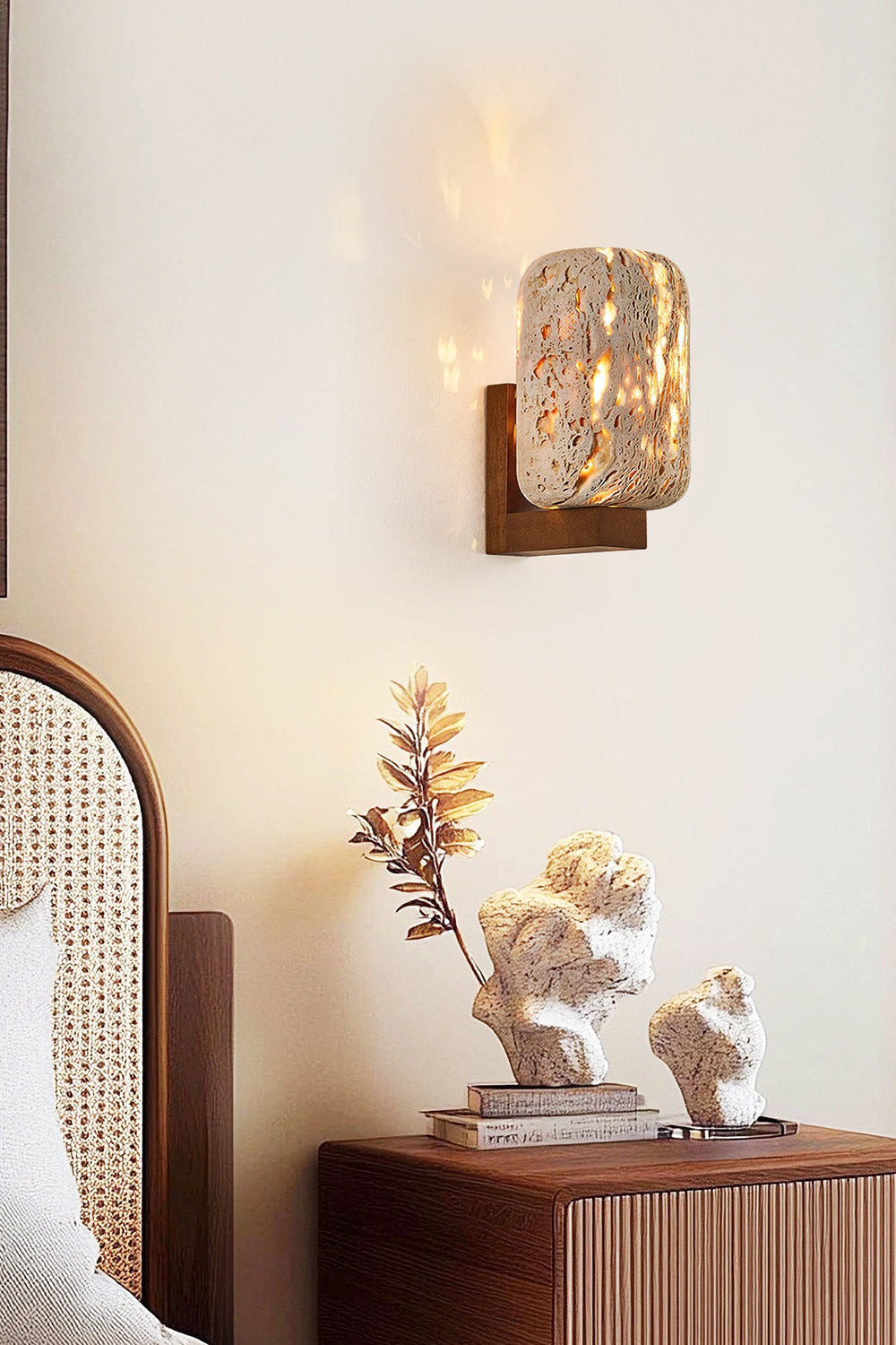 Lit travertine wall lamp in a cozy bedroom nook | Travertine, Wood | Installed near a rattan headboard and decor | vexa lamps