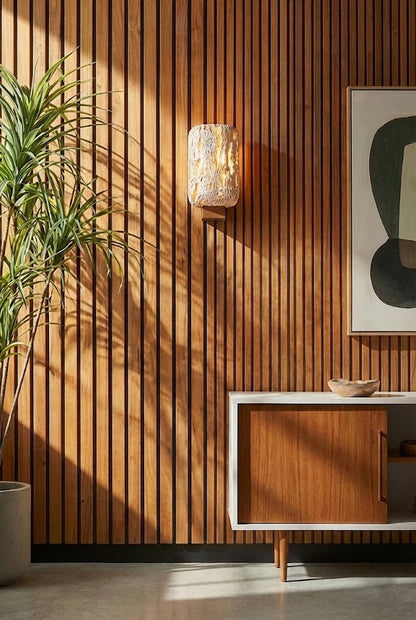 Travertine wall light on a vertical wood slat panel | Travertine, Wood | Modern organic interior scene with green plant | vexa lamps