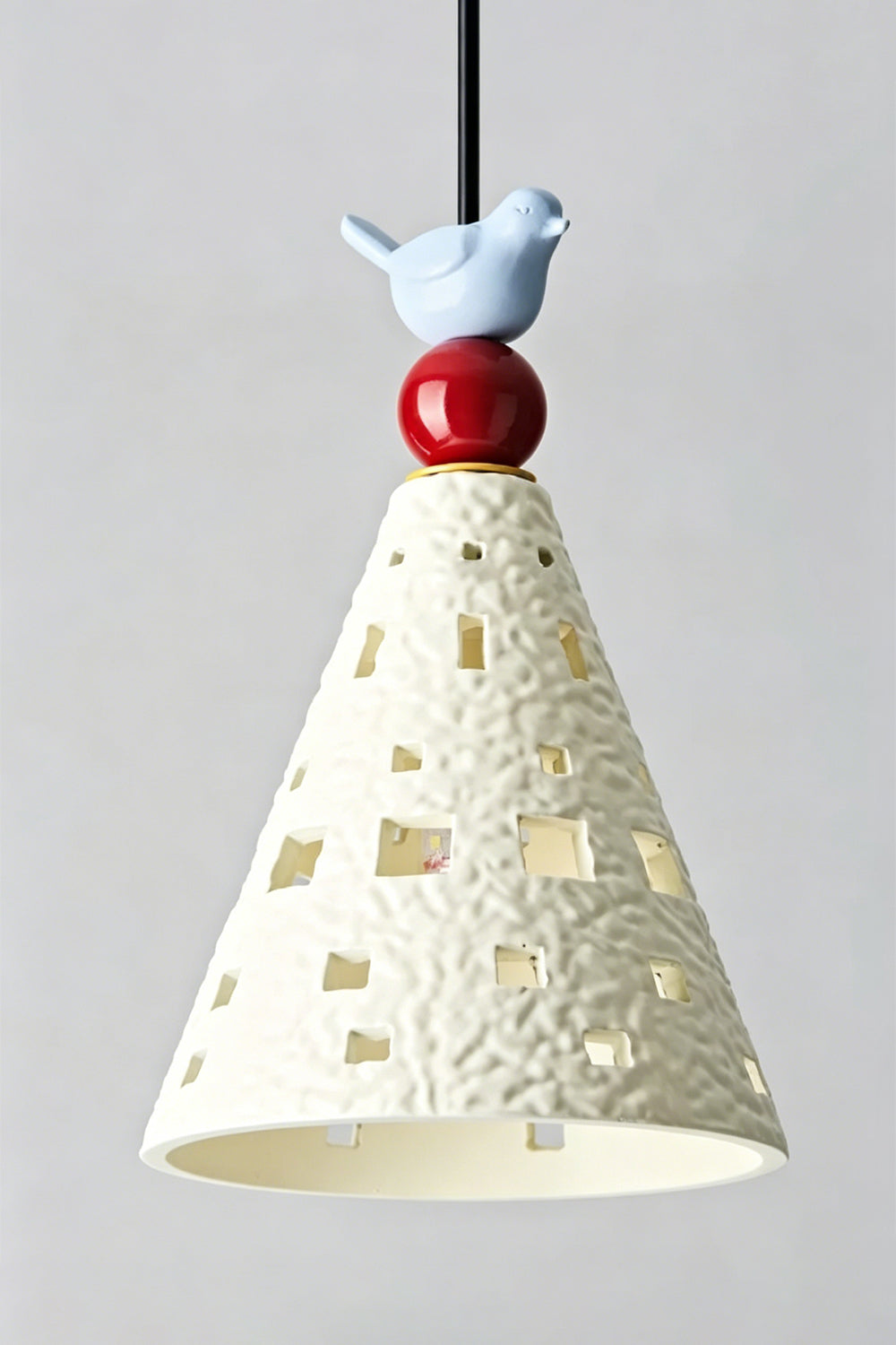 Whimsy Ceramic & Resin Pendant Light featuring a tapered ceramic cone shade and sculptural bird detail.