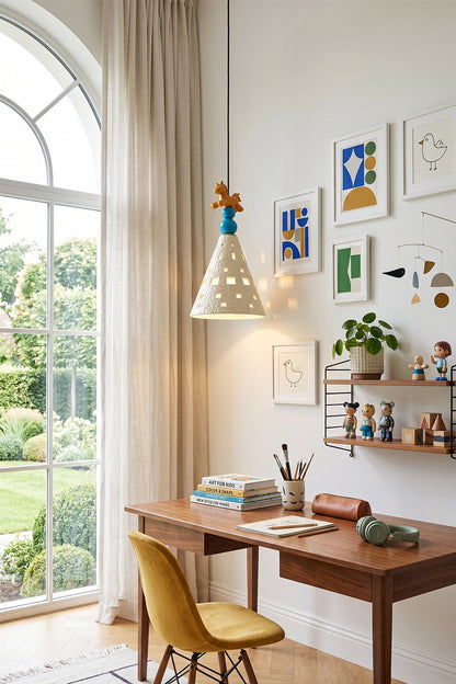 Whimsy Ceramic & Resin Pendant Light illuminating a stylish workspace with artwork and a cozy desk.