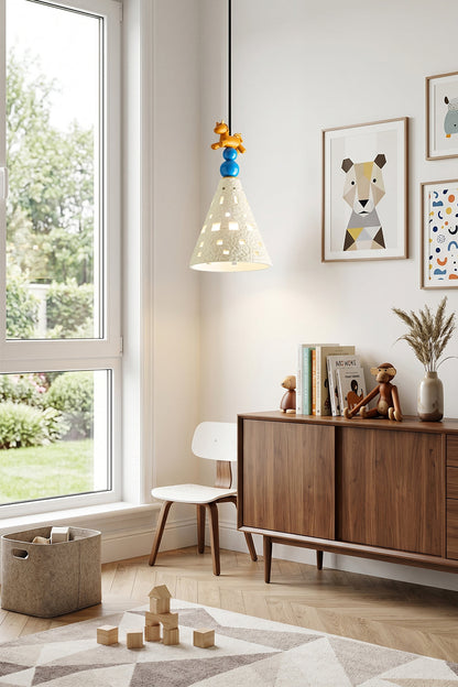 Whimsy Ceramic & Resin Pendant Light illuminating a stylish nursery with geometric patterns and playful decor.