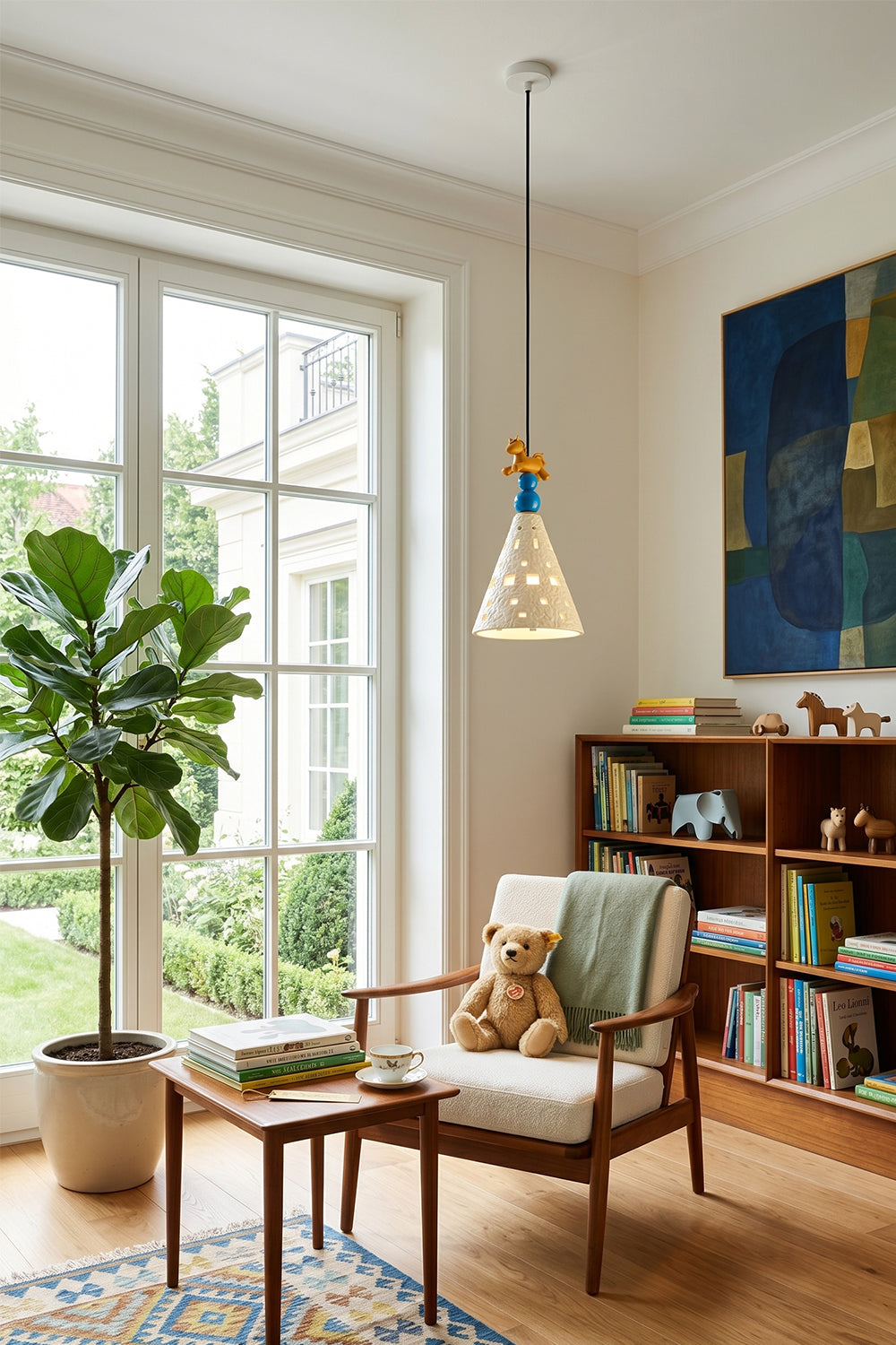 Whimsy Ceramic & Resin Pendant Light hanging in a children's room with a cozy chair and bookshelves.