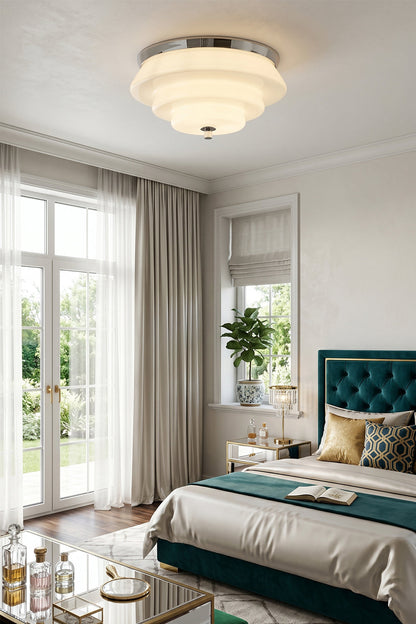 Ziggurat Horizon Glass Ceiling Light illuminating a stylish bedroom with curtains and decor.